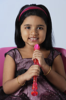 Little holding recorder/flute - Asia Images Group