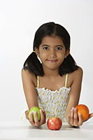 girl holding fruits - Asia Images Group