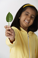 Girl holding leaf - Asia Images Group