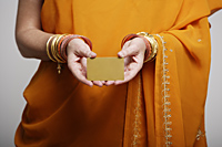 cropped shot of woman wearing sari holding credit card - Asia Images Group