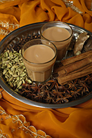 Indian masala tea with spices on silver tray. - Asia Images Group