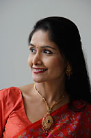 Head shot of Indian woman wearing a sari and smiling - Asia Images Group