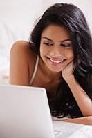 Close up of Indian woman looking at laptop computer - Asia Images Group