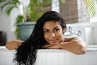 Indian woman in bath and looking at camera - Asia Images Group