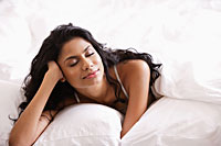 Indian woman relaxing in bed - Asia Images Group
