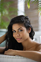 Indian woman taking a bath and looking at camera - Asia Images Group