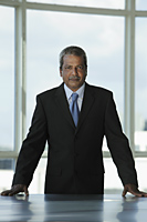Indian business man standing at desk - Asia Images Group