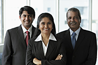 Three Indian people dressed in business suits and smiling - Asia Images Group