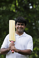 Indian man holding cricket bat - Asia Images Group