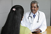Indian doctor talking to female patient - Asia Images Group