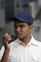 Security guard talking into walkie talkie - Asia Images Group