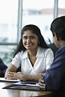 Indian woman smiling during meeting - Asia Images Group