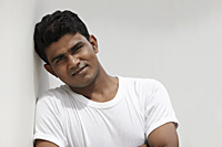 Head shot of man leaning against wall - Asia Images Group