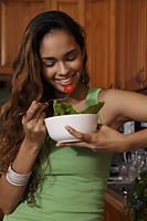Young woman eating salad - Asia Images Group