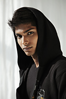 Head shot of young man wearing a hood - Asia Images Group