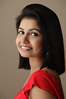 head shot of woman smiling and looking over her shoulder - Asia Images Group