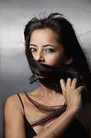 head shot of woman with hair in front of her face - Asia Images Group