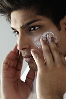 head shot of young man washing face - Asia Images Group