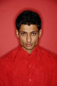 Man looking at camera, wearing red shirt - Asia Images Group