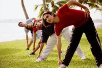 Young adults doing stretching exercises - Asia Images Group