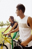 Two young men on bicycles, sideview - Asia Images Group