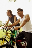 Two young men on bicycles - Asia Images Group
