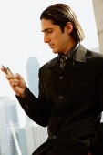 Businessman looking at mobile phone - Asia Images Group
