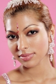 Young woman with Indian jewellery, looking at camera, head shot - Asia Images Group