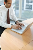 Male executive using laptop, high angle view - Asia Images Group
