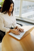 Female executive using laptop, portrait - Asia Images Group