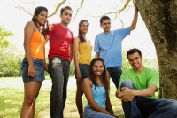Group of young adults in park, looking at camera, portrait - Asia Images Group