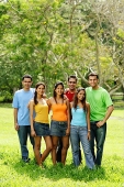 Group of young adults standing in park, looking at camera - Asia Images Group