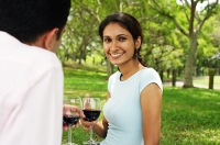 Couple holding wine glasses, woman looking at camera - Asia Images Group