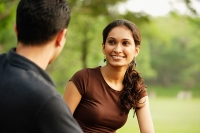 Woman facing man, smiling - Asia Images Group