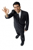 Businessman, hands raised, making hand sign - Asia Images Group