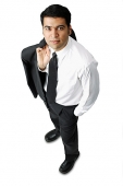 Businessman carrying jacket over shoulder, hands in pocket - Asia Images Group