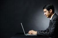 Businessman using laptop - Asia Images Group