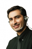 Man using headset, smiling, looking at camera - Asia Images Group