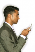 Businessman using mobile phone, text messaging - Asia Images Group