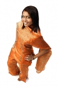 Woman in Indian clothing, hand on hip, smiling at camera - Asia Images Group