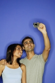 Couple taking a picture of themselves - Asia Images Group