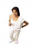 Woman standing, towel on shoulder, holding toothbrush - Asia Images Group