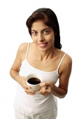 Woman holding cup of coffee - Asia Images Group