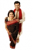 Indian couple in traditional clothing, looking up at camera - Asia Images Group