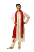 Indian man in traditional clothing, looking at camera, hands on hip - Asia Images Group