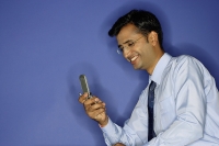 Man using mobile phone, smiling - Asia Images Group