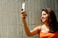 Woman taking a photo using mobile phone - Asia Images Group