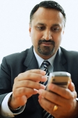 Businessman using PDA phone - Asia Images Group