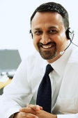 Man using headset, smiling at camera - Asia Images Group
