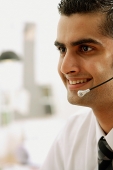 Executive using headset, smiling, head shot - Asia Images Group